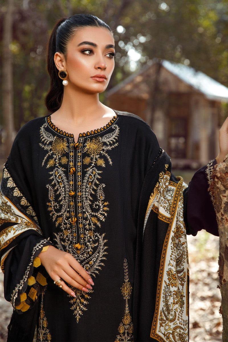 Woman wearing a black embroidered outfit with gold details outdoors.
Elegant Pakistani winter 3pc suit in linen fabric