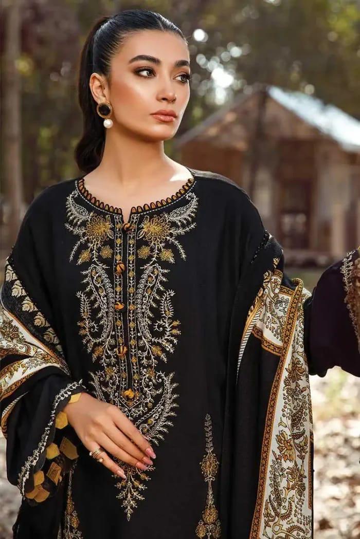 Woman wearing a black embroidered traditional outfit with gold details outdoors.Elegant Pakistani winter 3pc suit in linen fabric