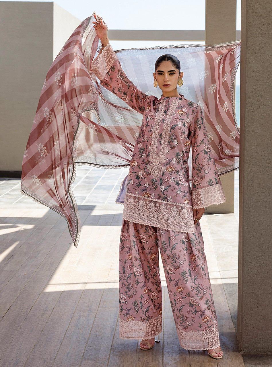 Woman in a pink floral traditional outfit with a matching dupatta, standing indoors.
Elegant Pakistani winter 3pc suit in linen fabric