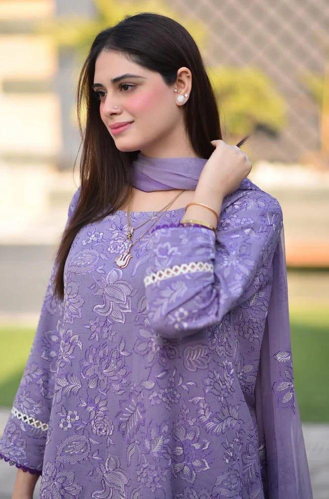 Woman wearing a purple embroidered outfit with a matching dupatta outdoors.
Elegant Pakistani winter 3pc suit in linen fabric.