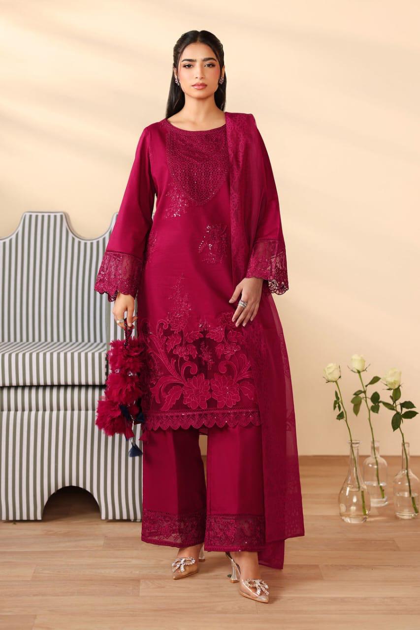 Woman wearing a burgundy embroidered outfit with a beige background.
Elegant Pakistani winter 3pc suit in linen fabric